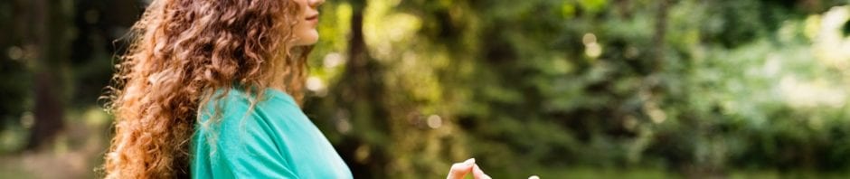 Girl practices yoga outside