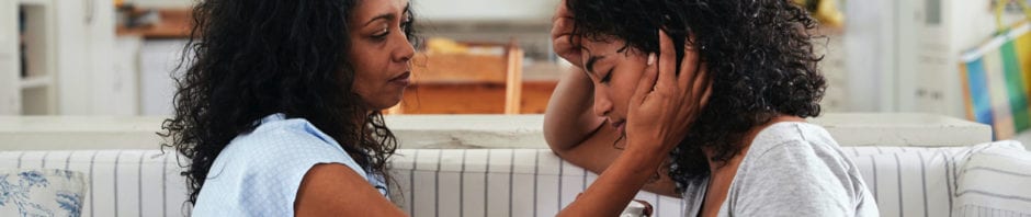 Situational Anxiety - Mother talking with stressed daughter on their couch