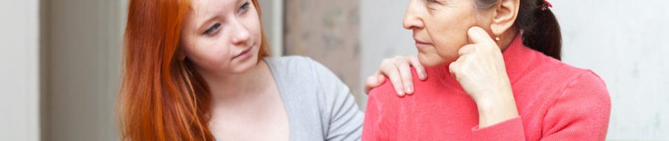 Teenage girl comforting her mother