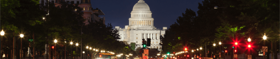 The United States Capitol building and Constitution Avenue in Washington DC at night