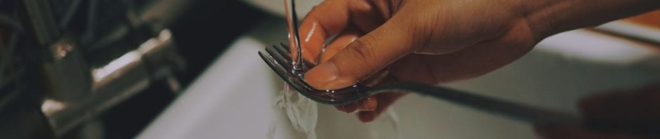 Kid washing silverware