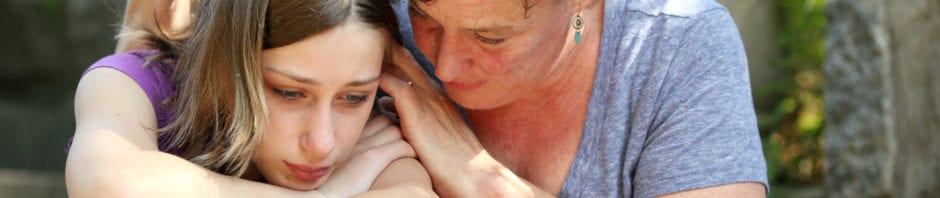 Mother comforting sad daughter