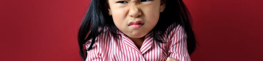 Oppositionality - young girl with arms crossed and angry look