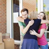 Kids leave home - Parents hugging goodbye their teenager